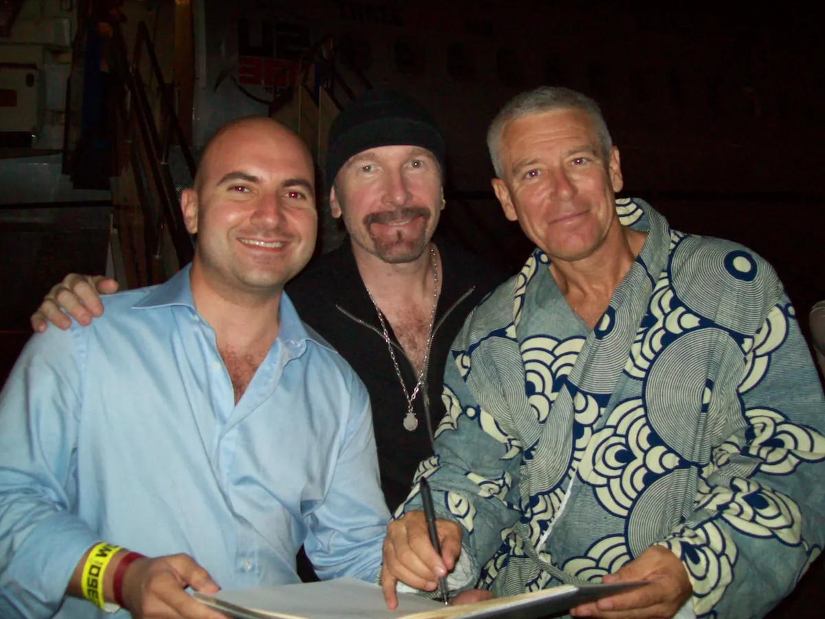 The Edge and Adam Clayton of U2 with Orkun Biliş, Co-Founder of Illusthrone, in a publicly shareable artist hospitality context in Istanbul
